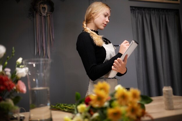 Female florist holding a notebook