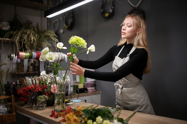 Female florist making a beautiful arrangement of flowers