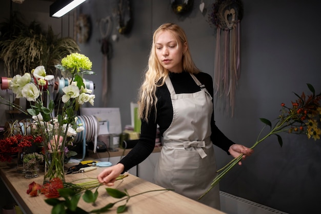 Female florist making a beautiful arrangement of flowers