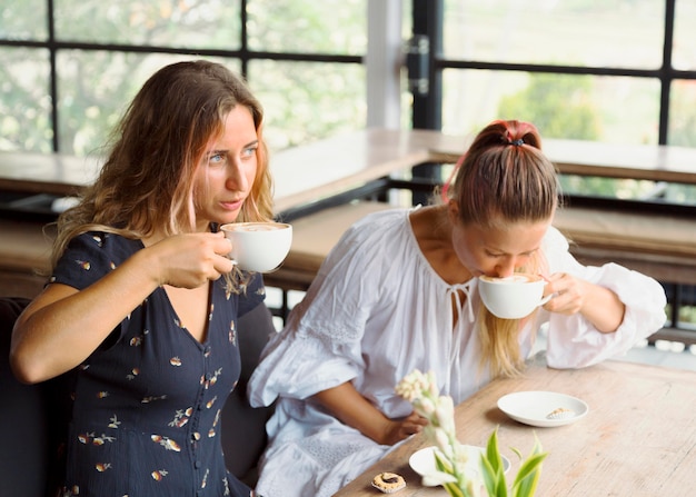 Female friends having coffee together