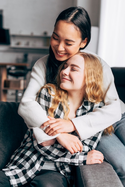 Free Photo female friends at home hugging