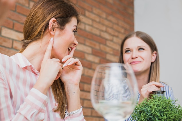 Female friends laughing in bricks room