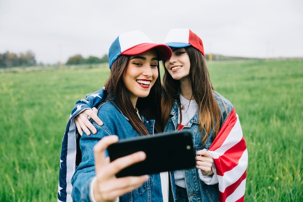 Female friends posing on phone camera