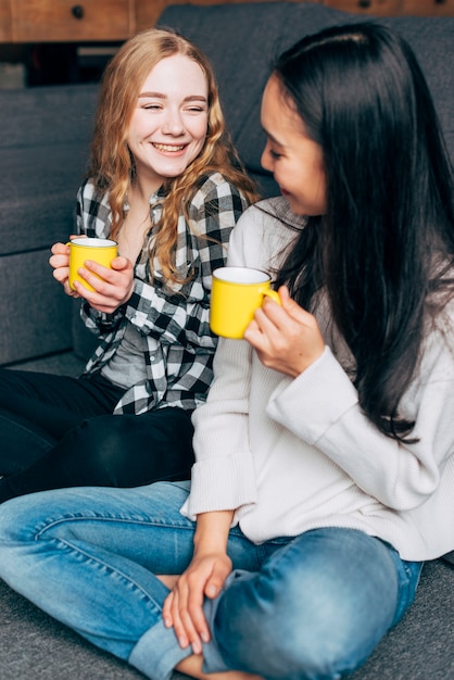 Female friends talking and drinking tea