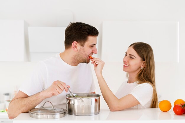 Female giving man to taste