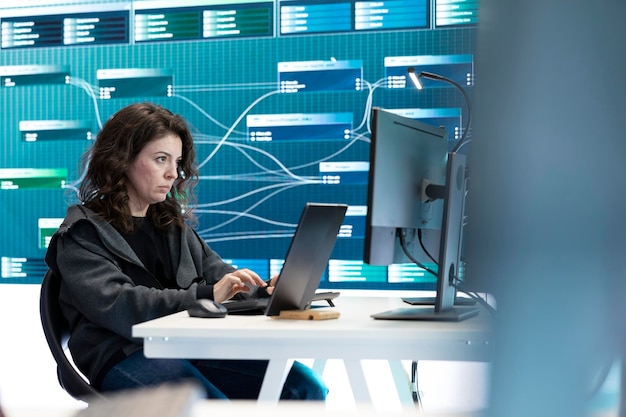 Free Photo female governmental hacker examines data on a computer in agency center