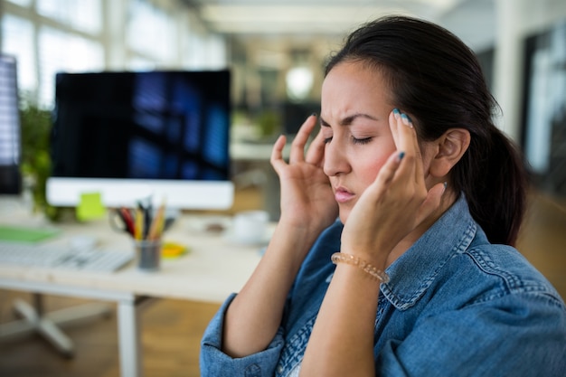 Free photo female graphic designer suffering from head pain