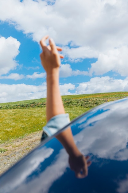 Free photo female hand against sky