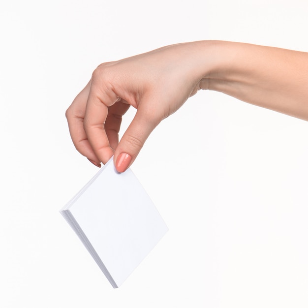 Female hand holding blank paper for records on white.