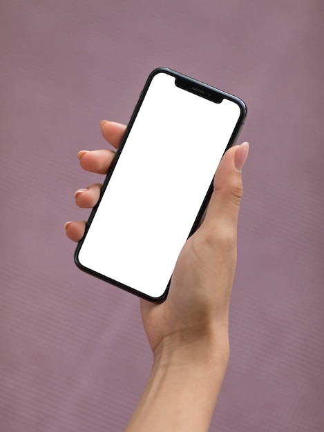 Female hand holding a smartphone with blank screen