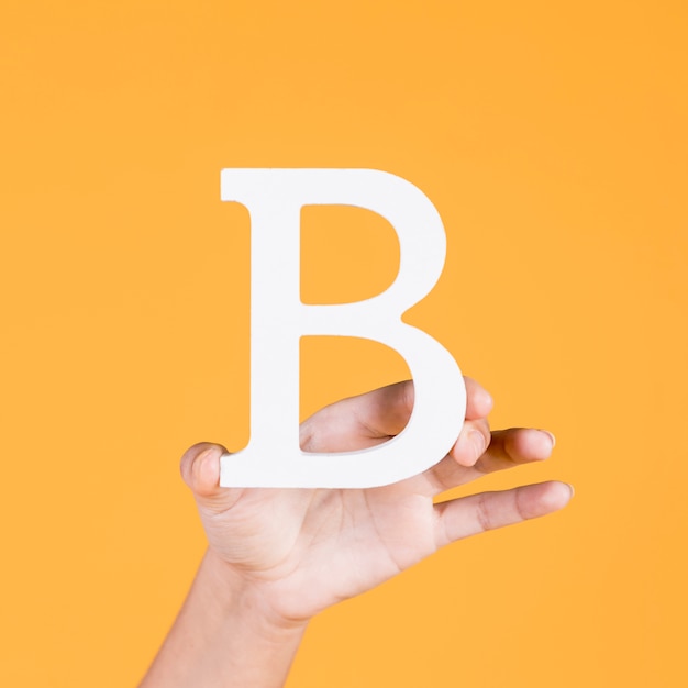 Female hand showing the white uppercase letter b