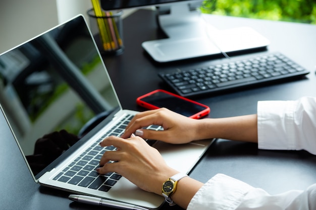 Free Photo female hand typing on keyboard of laptop