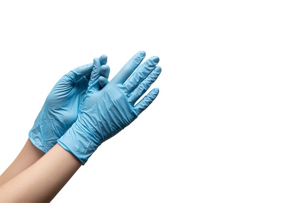 Female hands in disposable gloves on white background.