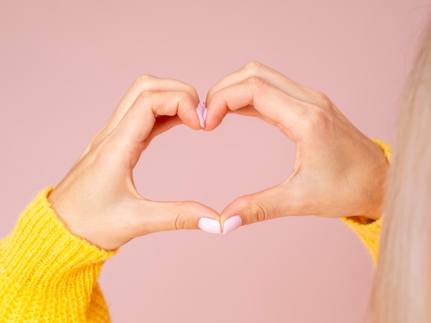 Free photo female hands gesturing heart