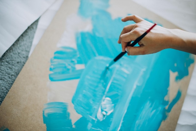 Female hands with painting brushes