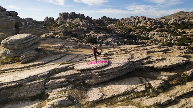 Female in the heart of nature practicing yoga