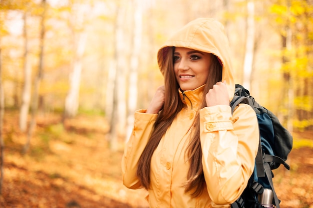 Free photo female hiker protecting against rain