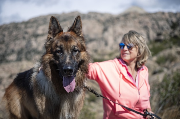 Female hiker resting with her dog and enjoying the fresh air