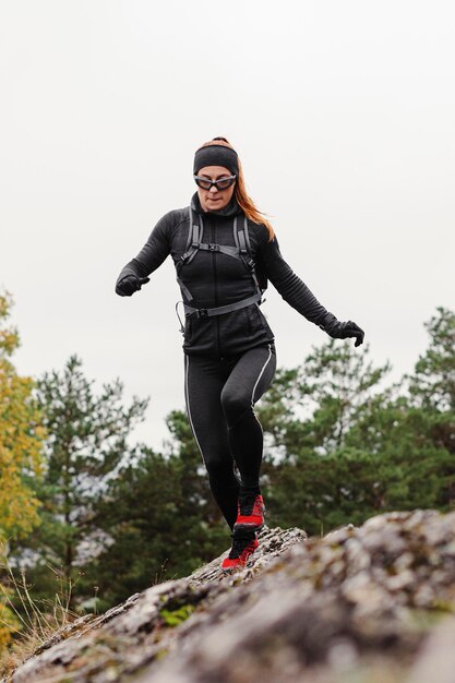 Female jogger running on stones