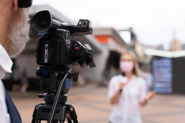 Female journalist telling the news outside