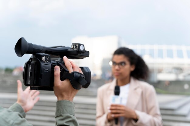 Female journalist telling the news outside