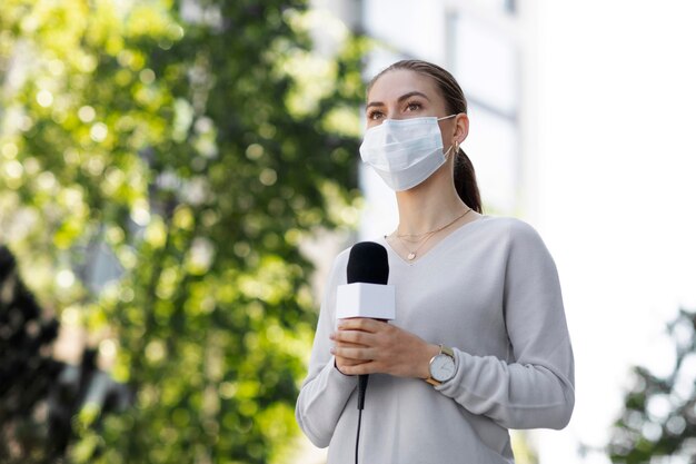 Female journalist with medical mask