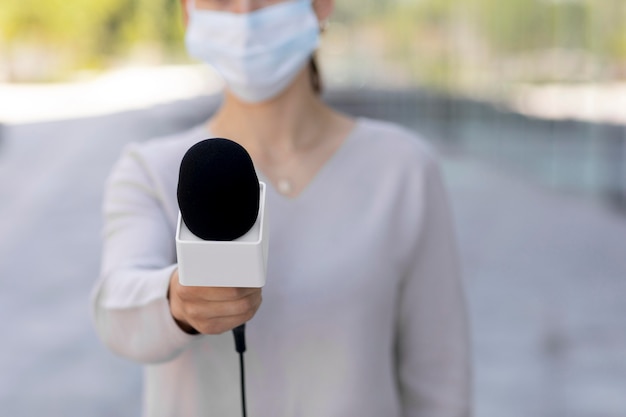 Female journalist with medical mask