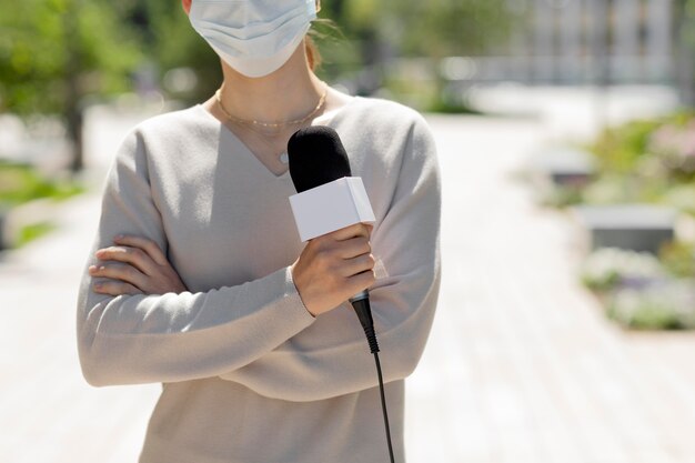 Female journalist with medical mask