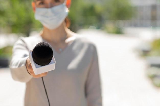 Female journalist with medical mask