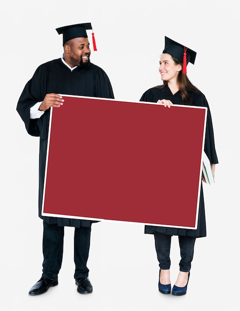 Free Photo female and male grad holding a copy space