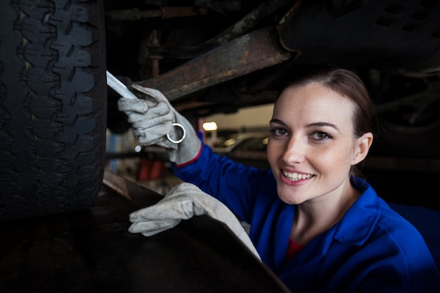 Female mechanic servicing a car