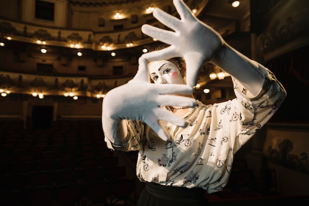 Free Photo female mime making a hand frame