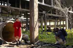 Free photo female model being photographed with grunge environment during urban exploration