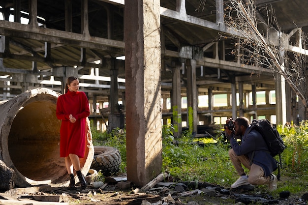 Free Photo female model being photographed with grunge environment during urban exploration