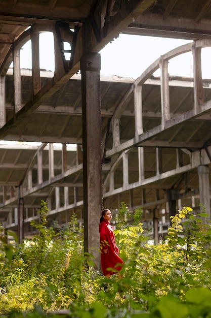 Female model being photographed with grunge environment during urban exploration