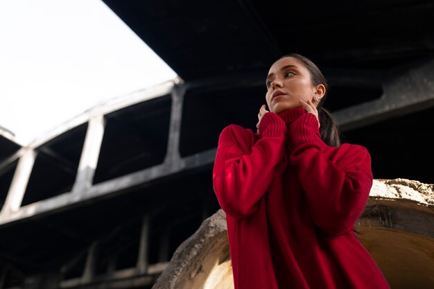 Female model being photographed with grunge environment during urban exploration