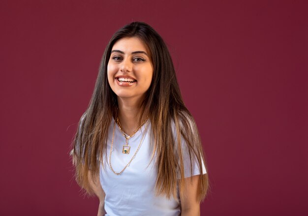 Female model posing on pink wall