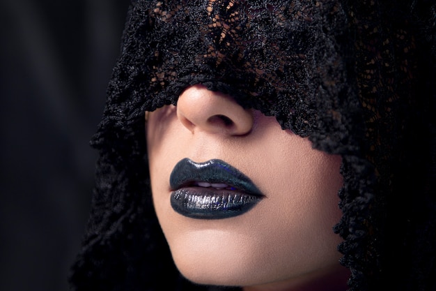 Free photo female model wearing gothic style makeup with black lace scarf