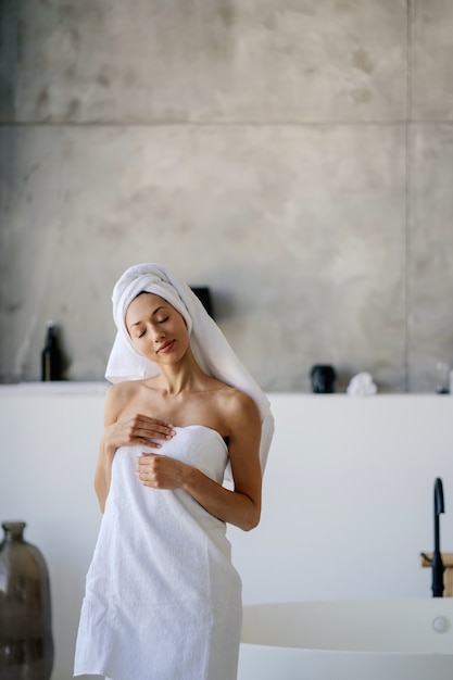 Female model in white towel. Women, beauty and hygiene concept.