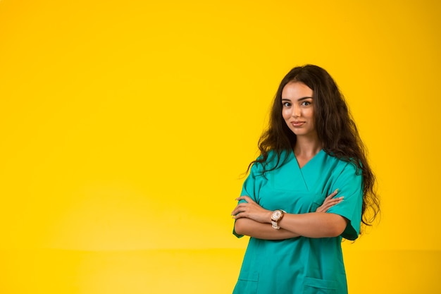 Female nurse closes arms and gives professional look