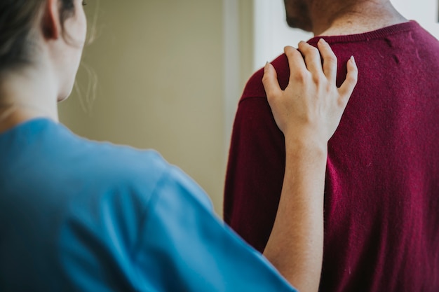 Free photo female nurse touching a patients shoulder