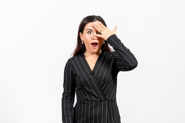 female office employee in strict black suit posing on white