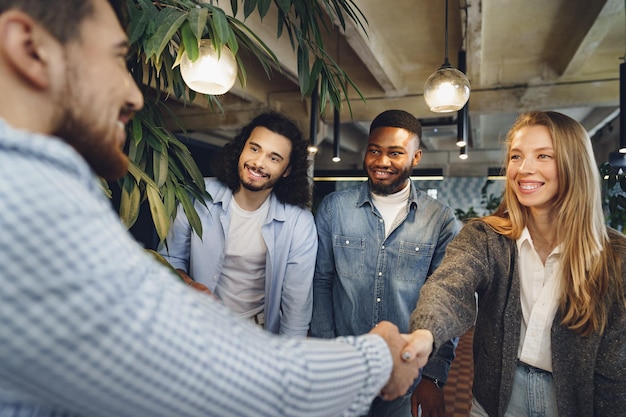 Free Photo female office executive shaking hand of new male team member employee