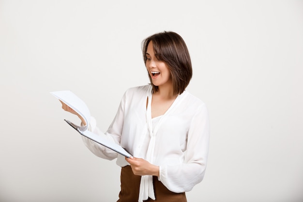 Female office worker reading documents