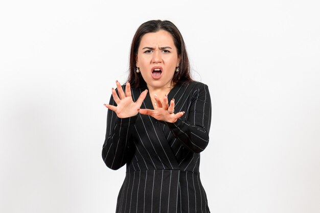 female office worker in strict black suit posing on white