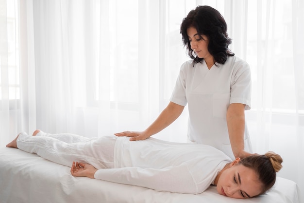 Female osteopathist treating a girl at the hospital