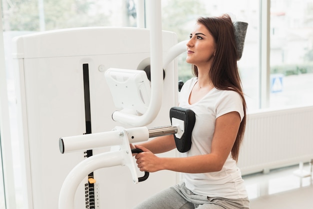 Free Photo female patient adjusting medical machine