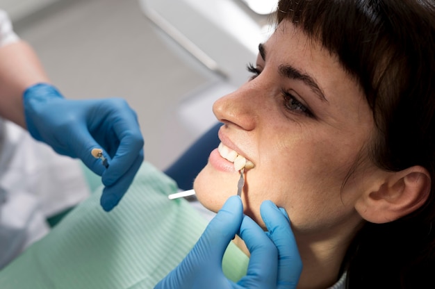 Free photo female patient having a procedure done at the dentist