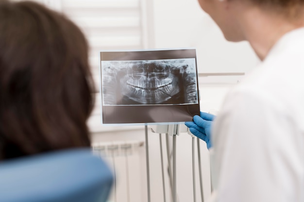 Female patient looking at a radiography of her teeth with the dentist