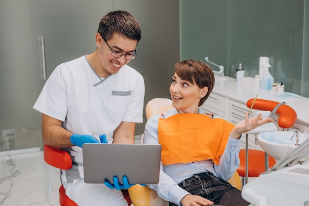 Free photo female patient sitting in a dentist chair and making professinal hygiene